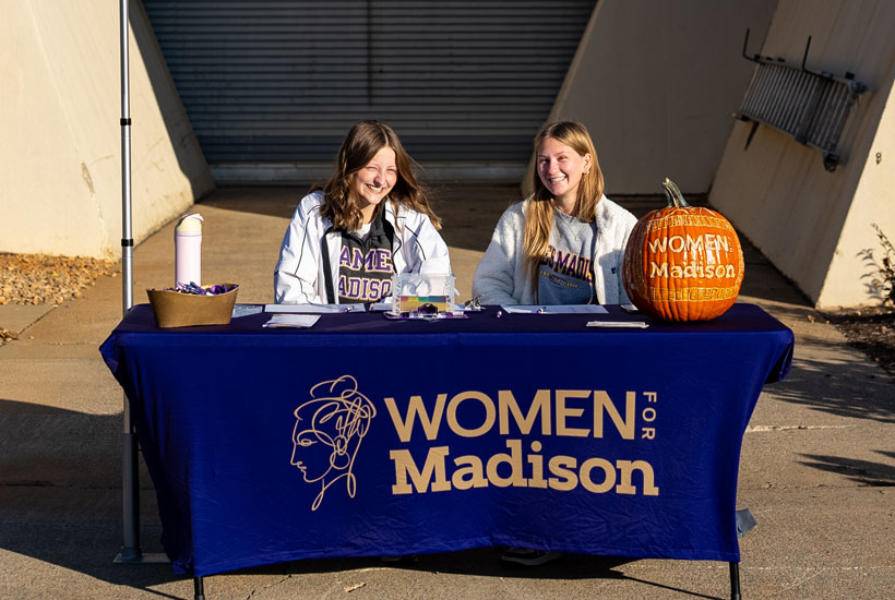 two students at a registration table 